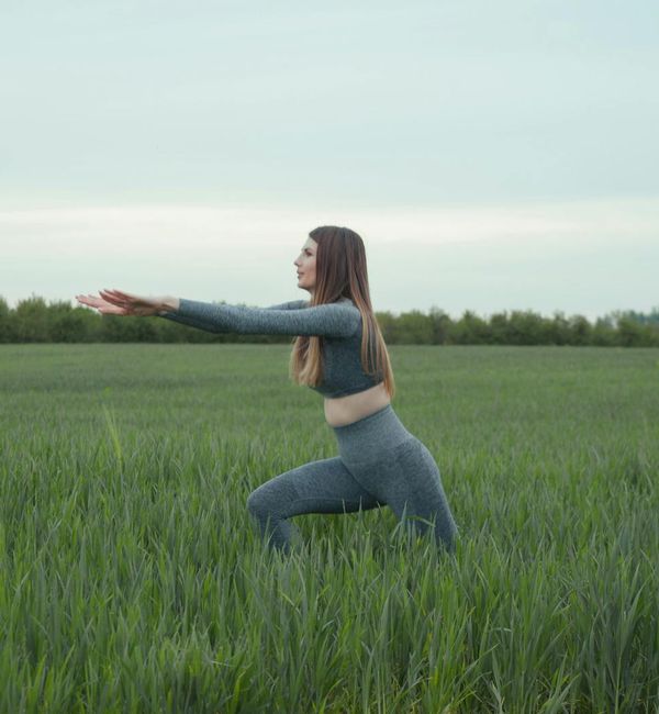 Person stretching outdoors during a beautiful sunrise.