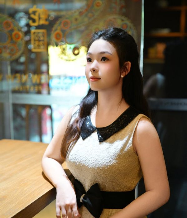 Woman in a graceful yoga pose with warm amber light accents.